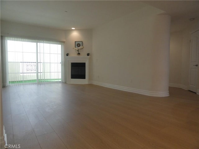 unfurnished living room with light hardwood / wood-style flooring