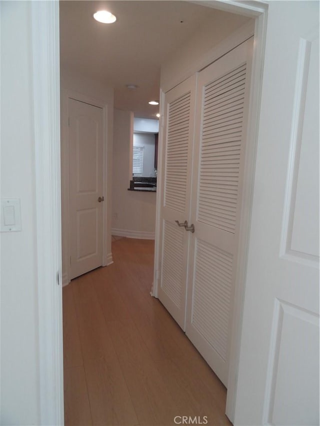 corridor with light hardwood / wood-style floors