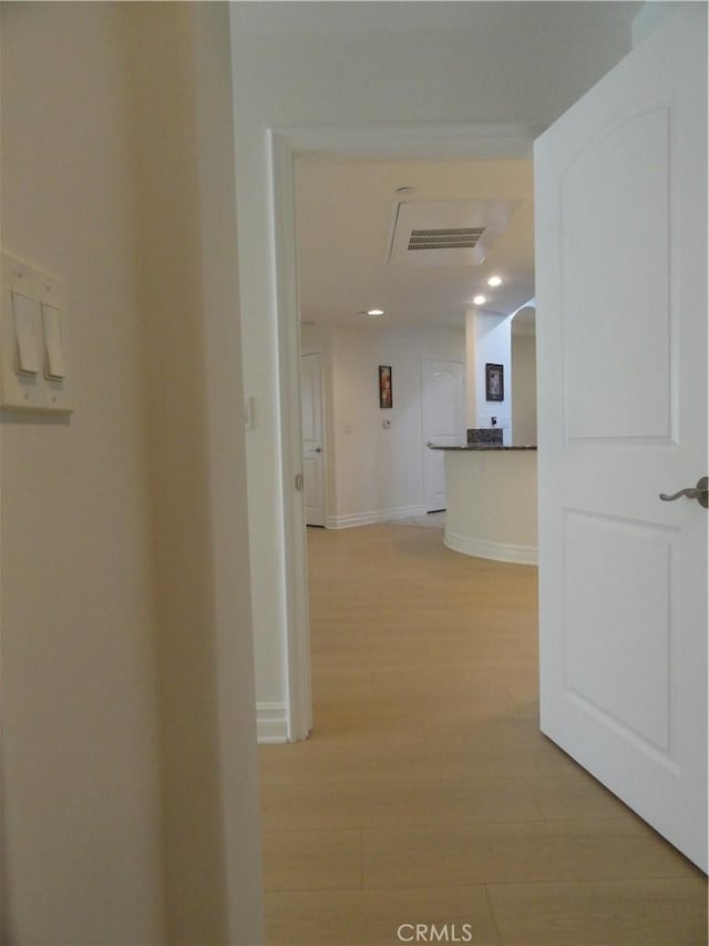 corridor with light hardwood / wood-style floors