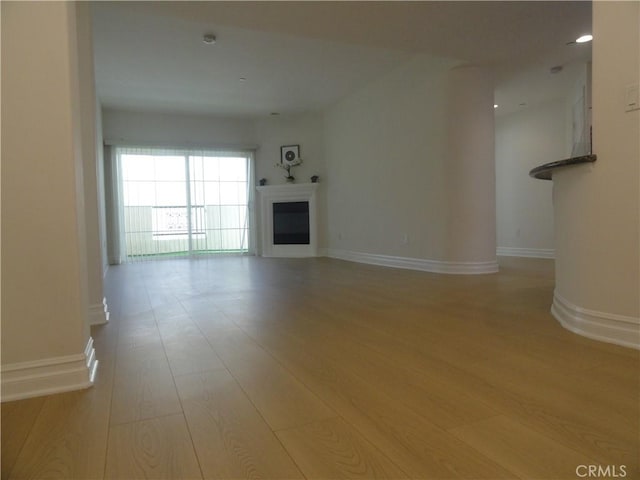 unfurnished living room with light hardwood / wood-style flooring