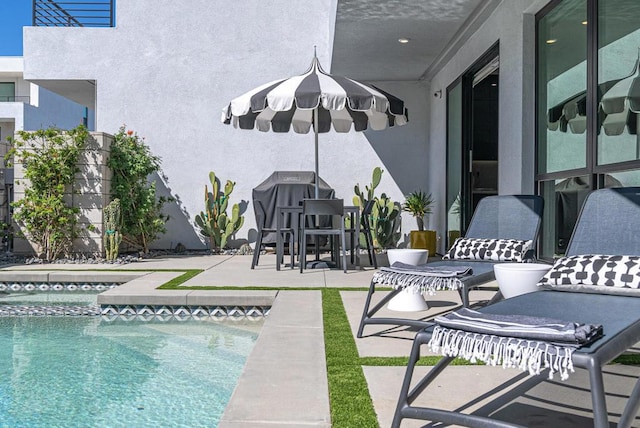 view of swimming pool featuring a patio area