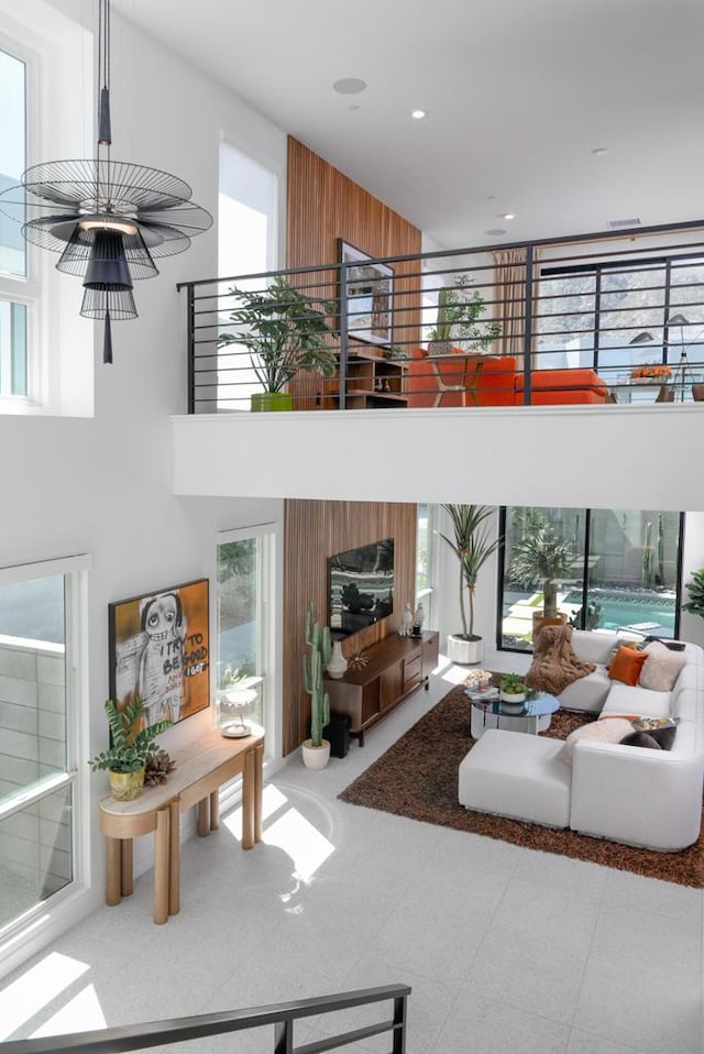 tiled living room featuring a towering ceiling