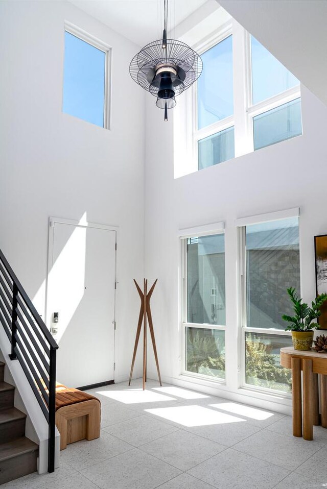 interior space featuring a towering ceiling and plenty of natural light