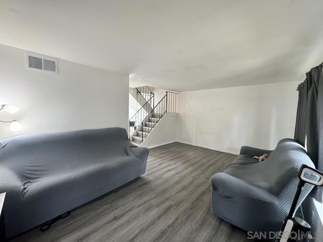 living room with dark hardwood / wood-style flooring