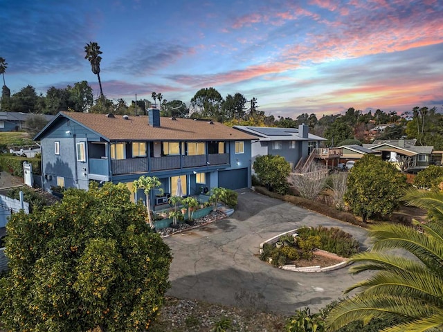 back house at dusk with a balcony