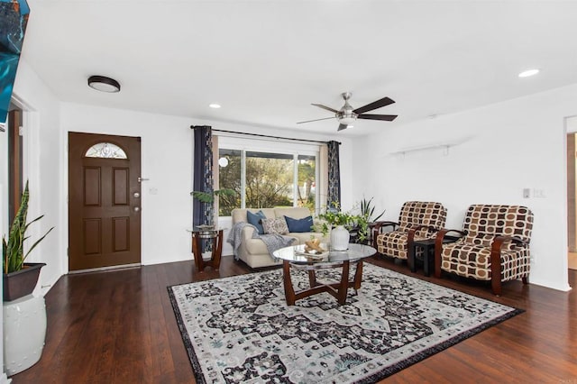 living room with ceiling fan and dark hardwood / wood-style floors