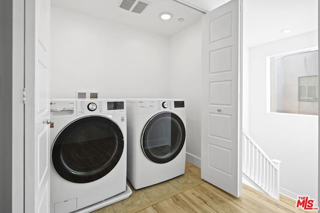 washroom with light tile patterned flooring and independent washer and dryer