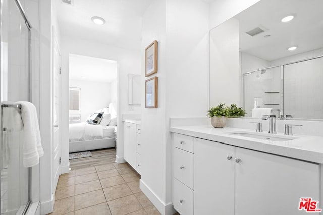 bathroom with vanity, tile patterned flooring, and walk in shower