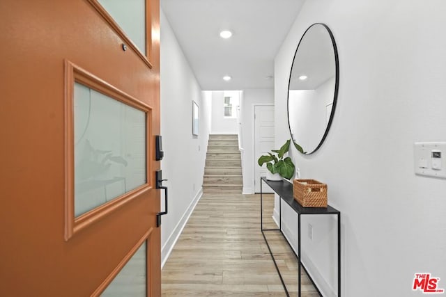 hallway with light hardwood / wood-style flooring