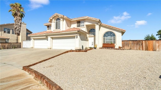 mediterranean / spanish-style home with a garage