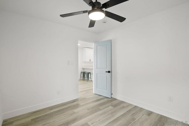 unfurnished room with ceiling fan and light hardwood / wood-style flooring