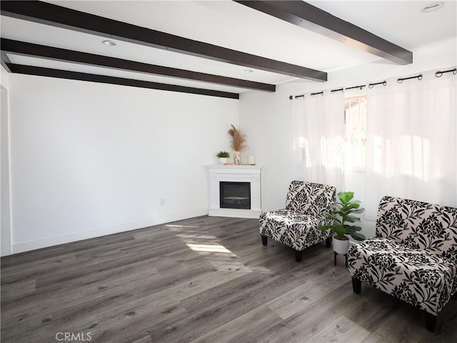 sitting room with wood-type flooring and beamed ceiling