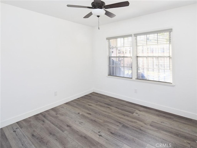 spare room with ceiling fan and dark hardwood / wood-style floors