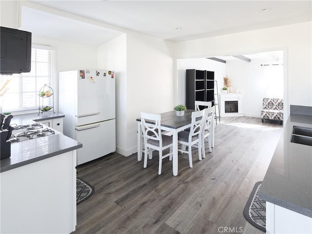 dining area with sink and dark hardwood / wood-style flooring