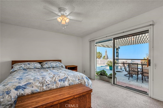 bedroom with ceiling fan, carpet, access to outside, and a textured ceiling