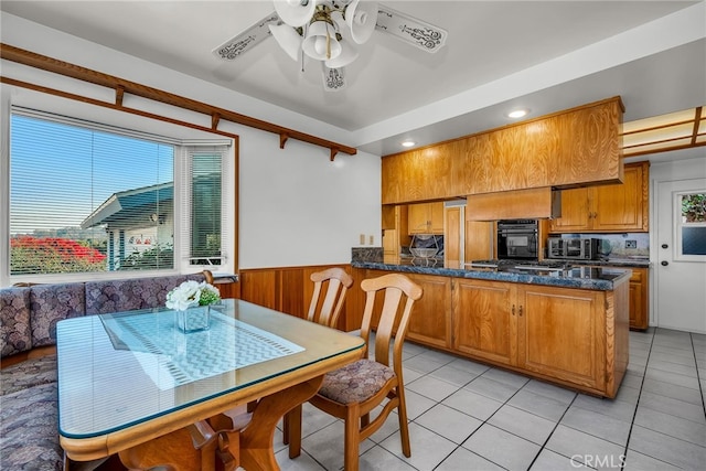 dining space with ceiling fan and light tile patterned flooring