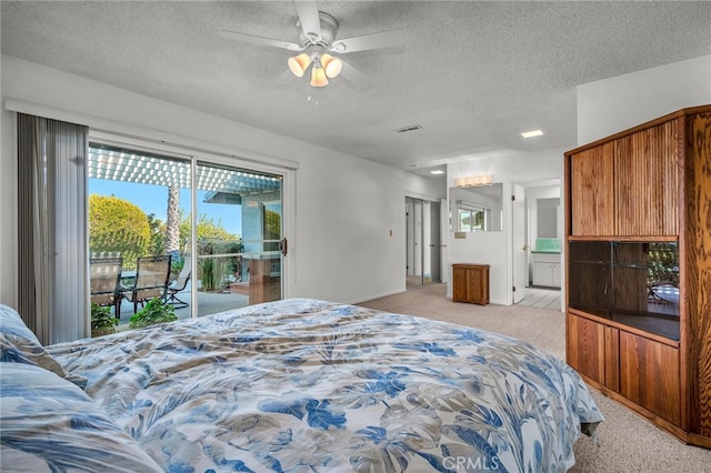 bedroom with connected bathroom, light colored carpet, access to exterior, ceiling fan, and a textured ceiling