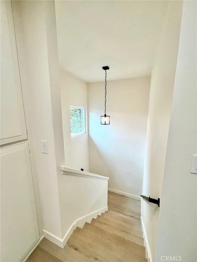 stairs with baseboards and wood finished floors