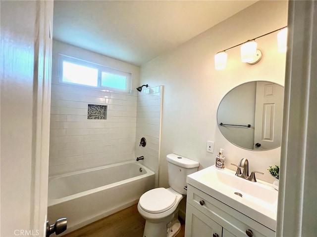 full bath featuring shower / bathing tub combination, toilet, wood finished floors, and vanity