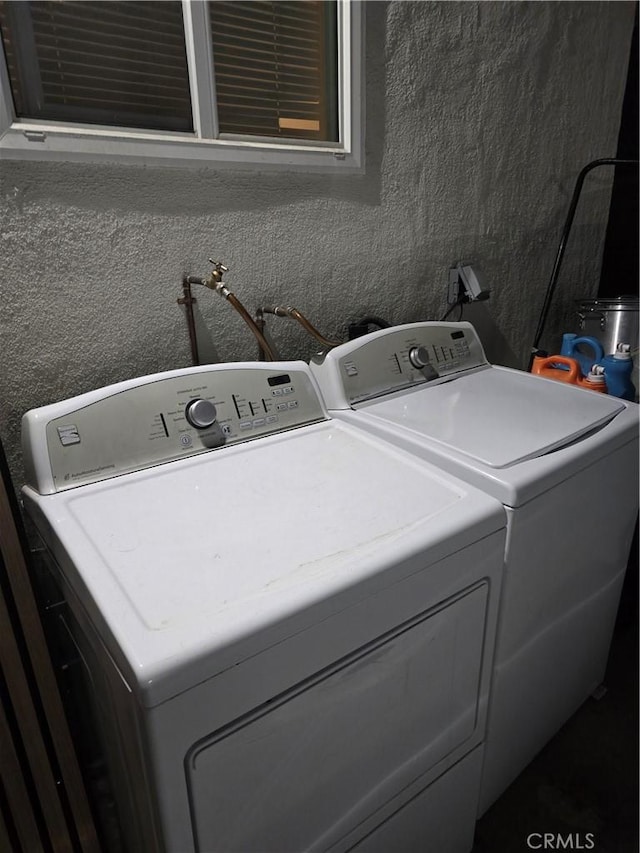 laundry area with separate washer and dryer