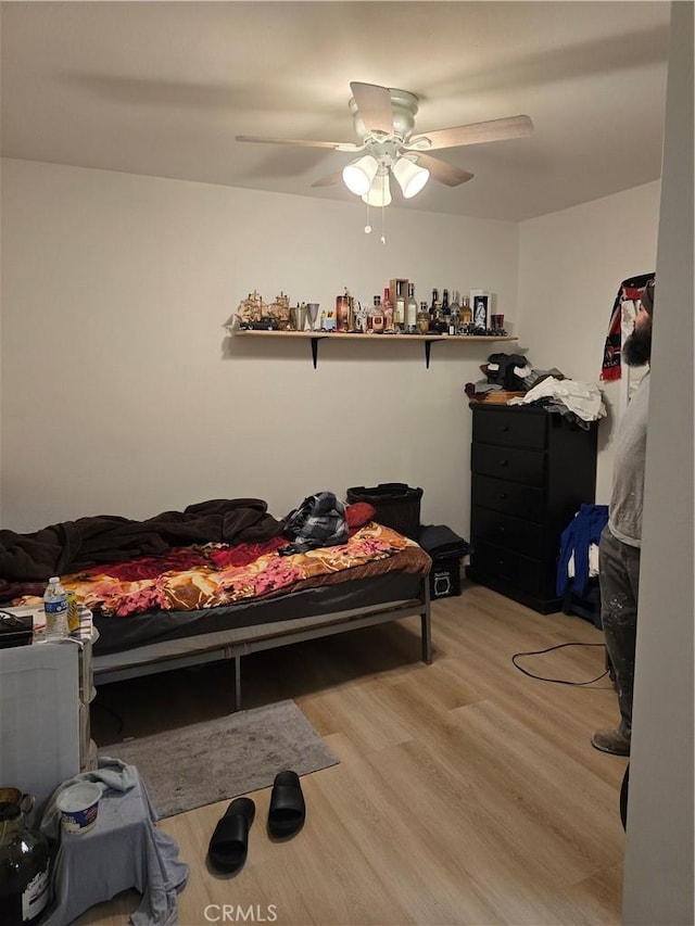 bedroom featuring ceiling fan and light hardwood / wood-style floors