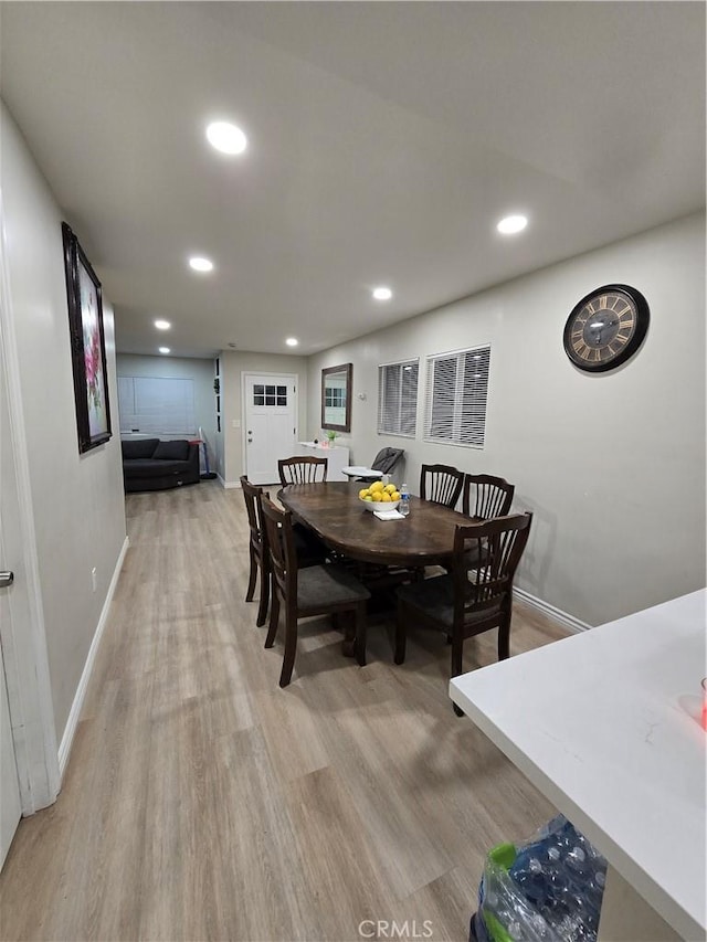 dining space with hardwood / wood-style flooring