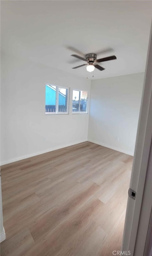 unfurnished room with ceiling fan and light wood-type flooring