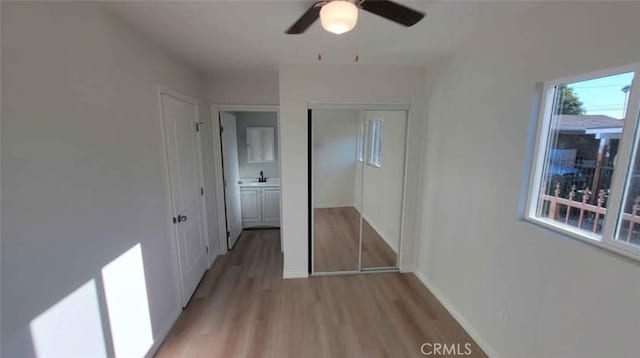 hallway with sink and light hardwood / wood-style floors