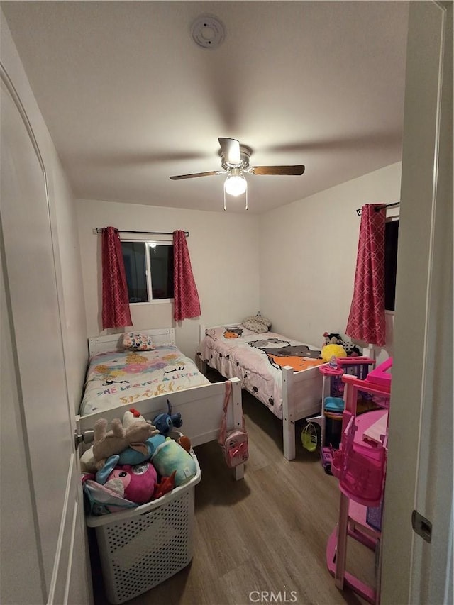 bedroom with hardwood / wood-style floors and ceiling fan