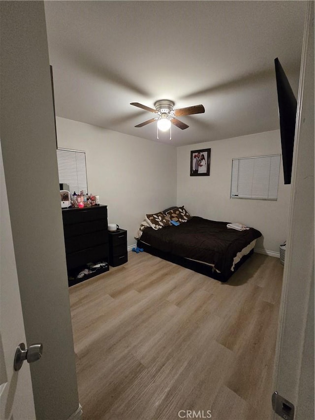 bedroom featuring ceiling fan and hardwood / wood-style floors