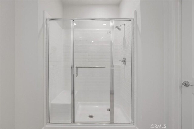 bathroom with a shower with shower door