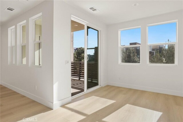 spare room featuring light hardwood / wood-style floors