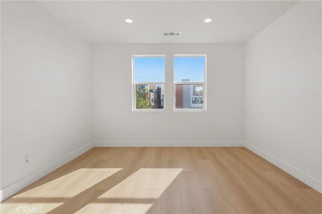 empty room with light hardwood / wood-style flooring