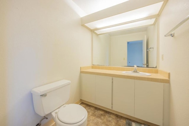 bathroom featuring toilet and vanity