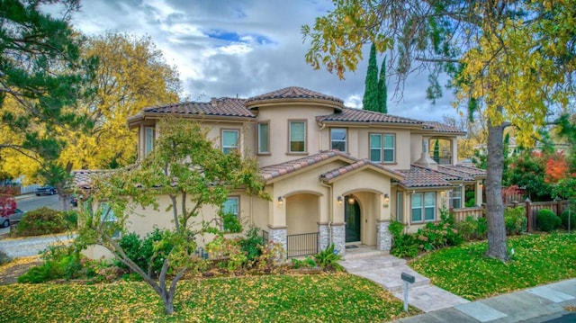 mediterranean / spanish-style house with a front lawn