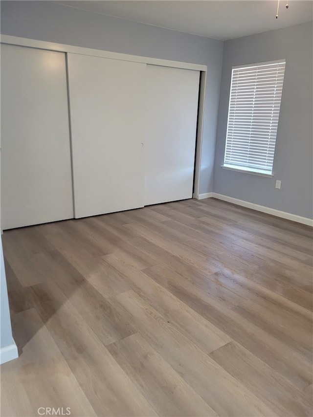 unfurnished bedroom with light hardwood / wood-style flooring