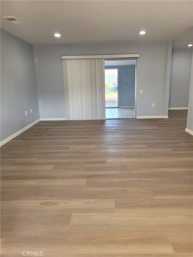 spare room with light wood-type flooring