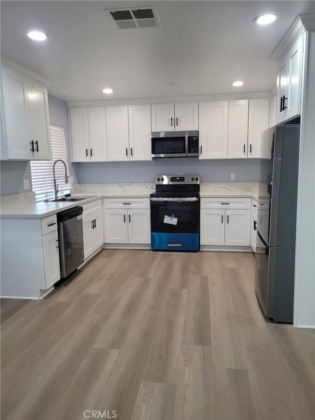 kitchen featuring sink, white cabinetry, and appliances with stainless steel finishes