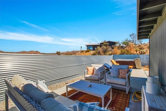 view of patio / terrace with a hot tub and outdoor lounge area