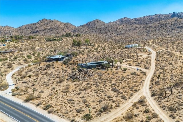 birds eye view of property featuring view of desert and a mountain view