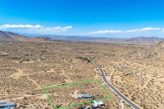 drone / aerial view featuring a mountain view, a rural view, and a desert view