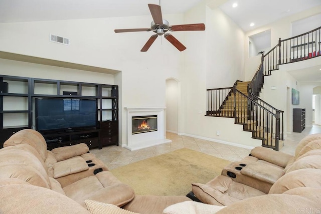 living room with high vaulted ceiling, light tile patterned floors, and ceiling fan