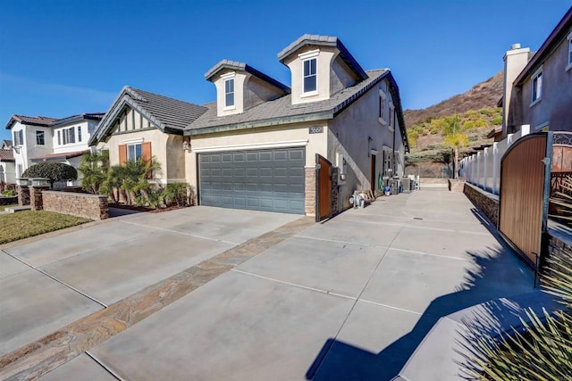 view of front facade featuring a garage and a mountain view