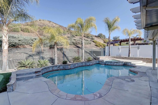 view of pool with a mountain view and an in ground hot tub