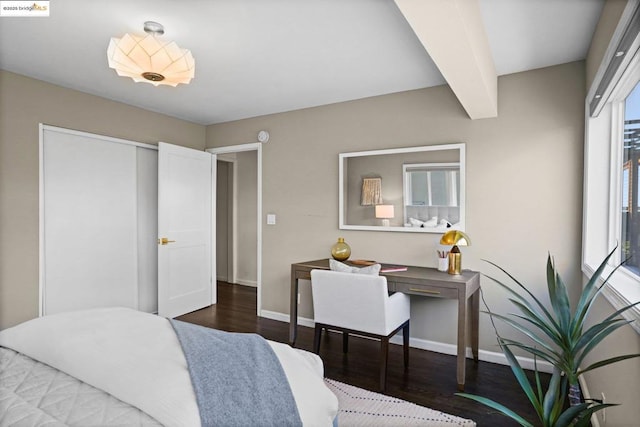 bedroom with beam ceiling, a closet, and wood-type flooring