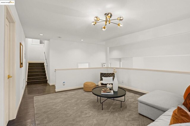 living area featuring hardwood / wood-style floors and an inviting chandelier