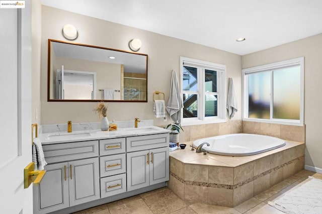 bathroom with vanity, tile patterned floors, and plus walk in shower