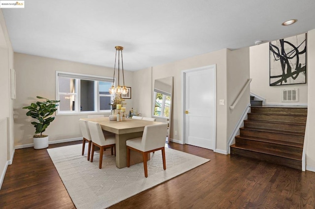 dining area featuring a notable chandelier and dark hardwood / wood-style floors