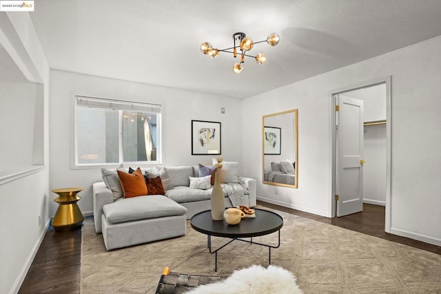 living room with dark hardwood / wood-style flooring and a chandelier