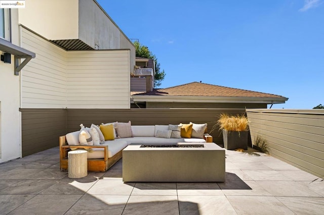 view of patio / terrace featuring an outdoor living space with a fire pit